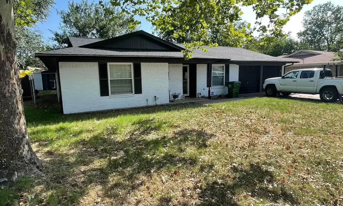 Professional roofing crew working on a residential roof in Hudson Falls